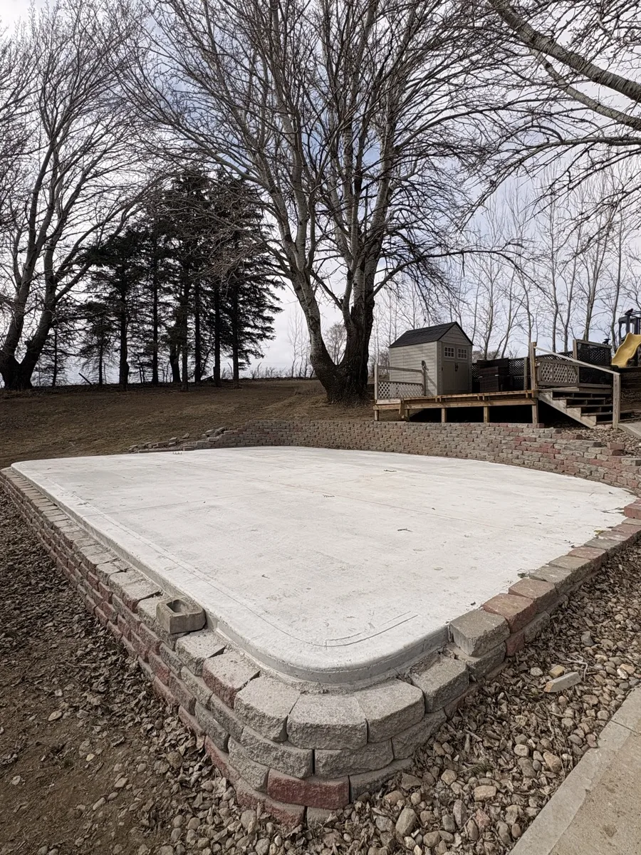Backyard patio concrete slab with brick border Siouxland Iowa