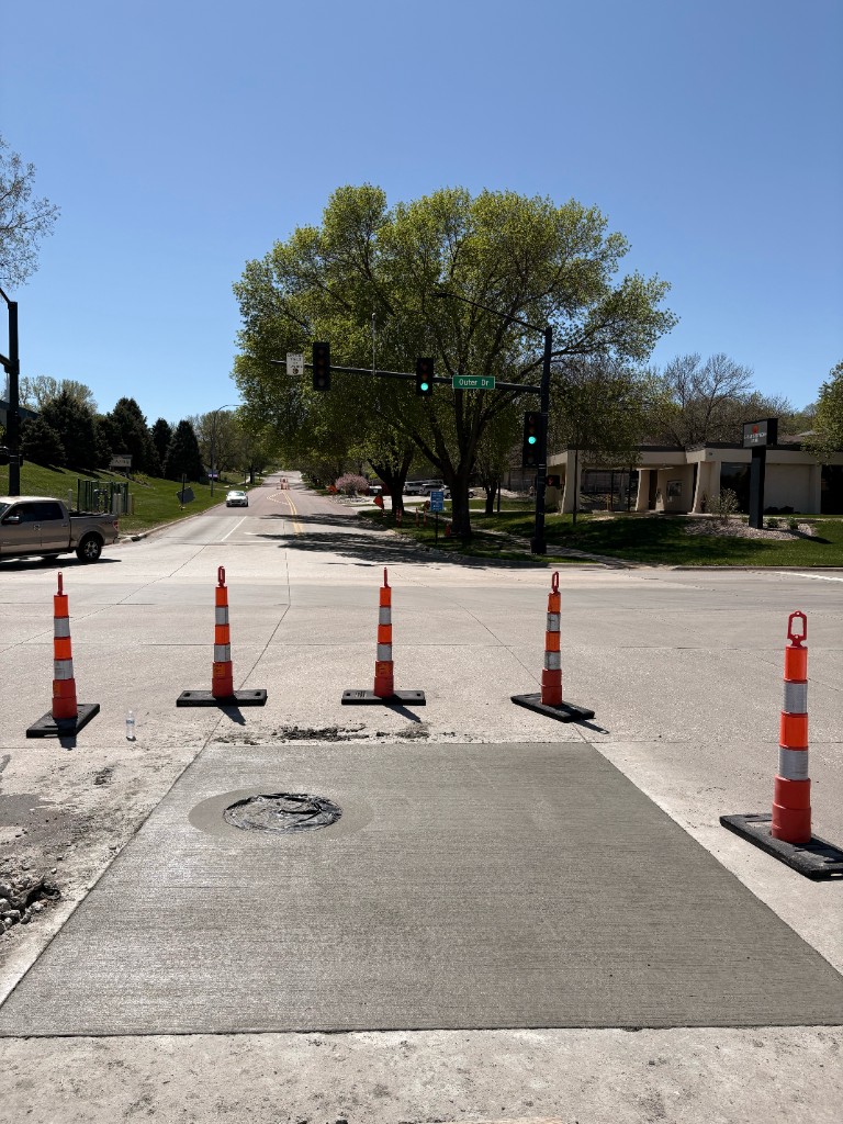 City street concrete repair and manhole at Outer Drive intersection in Sioux City, Iowa